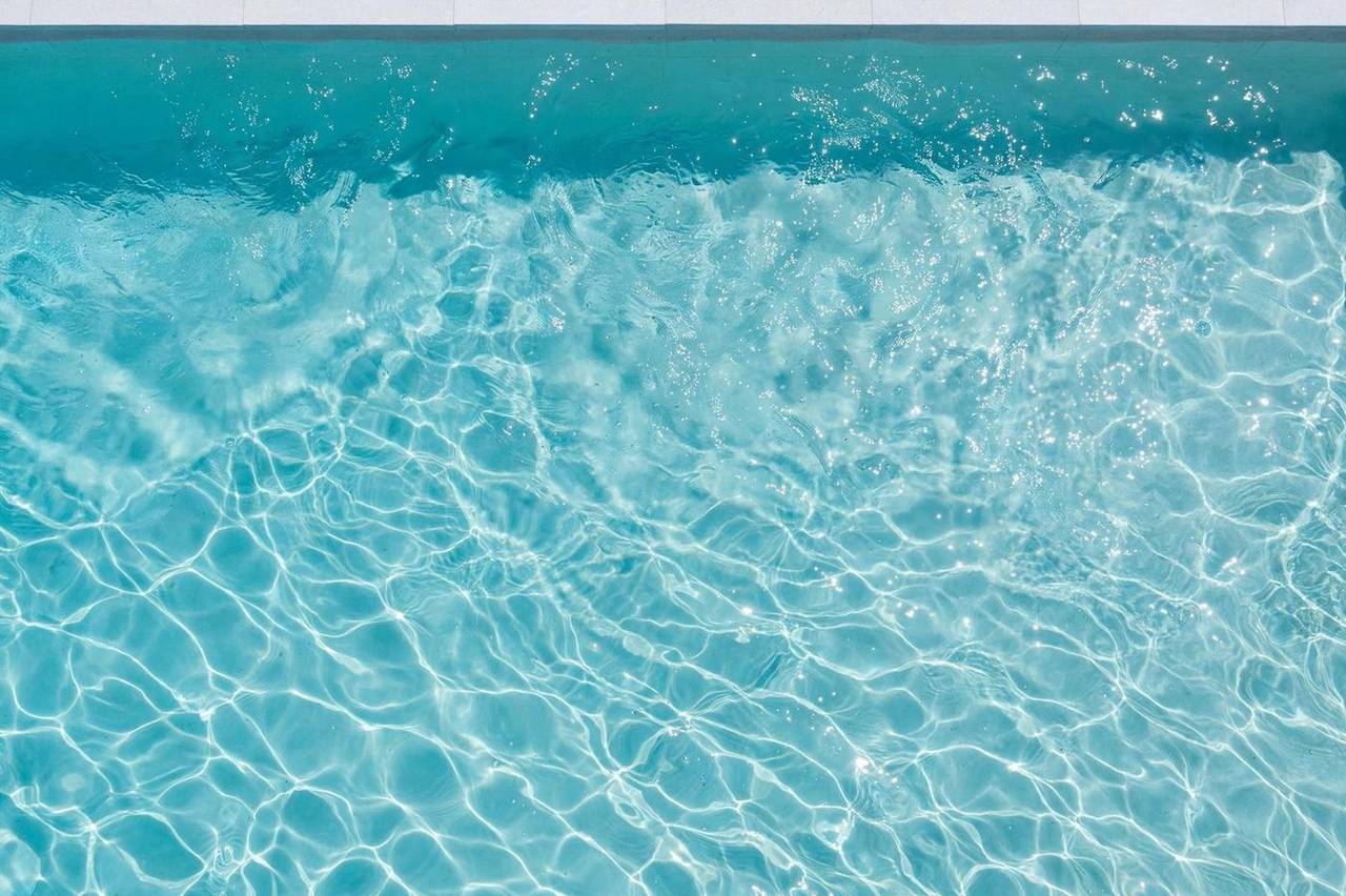 Crystal-clear swimming pool water in bright daylight